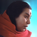 Shri Mataji with a red shawl, gazing down