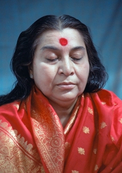 Shri Mataji, eyes closed, head and chest, red sari