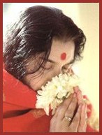 Shri Mataji Nirmala Devi smelling white flower
