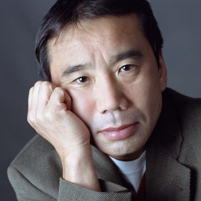 Haruki Murakami, looking pensive, head resting on his right hand