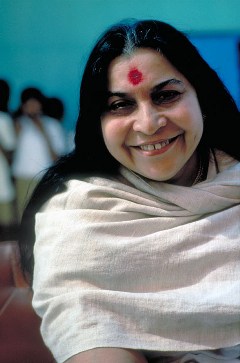 head and right shoulder of Shri Mataji, smiling with grey shawl