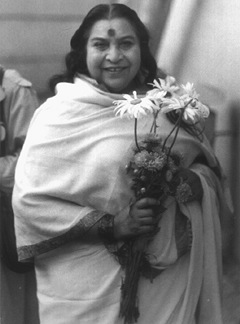 Shri Mataji Nirmala Devi at airport with large daisies