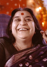 Shri Mataji Nirmala Devi, smiling, with navy blue sari