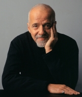 Paulo Coelho, looking bored but patient, head resting on left hand