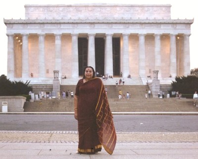 Shri Mataji standing outside Lincoln Memorial, Washington, burgundy and gold sari