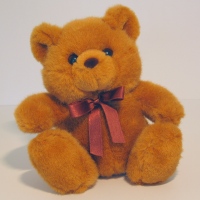 teddy bear and crimson bow around neck