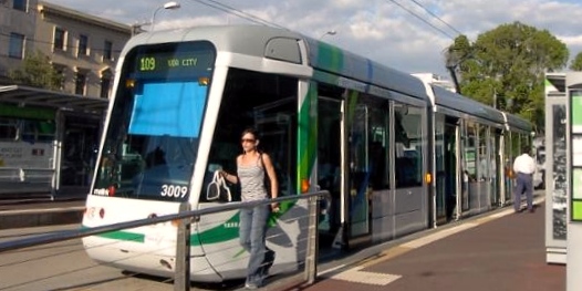 Melbourne Light Rail, three compartment vehicle at passenger stop Melbourne Light Rail, three compartment vehicle at passsenger stop