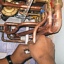 hands grasping copper pipe below boiler
