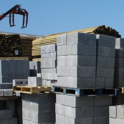 builders' merchant's yard with blocks and wood piled up