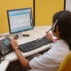 call centre operator with computer and telephone
