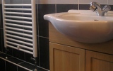 heated towel rail, washbasin with cupboard underneath