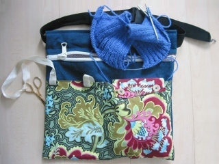 colourfully decorated sewing bag with scissors, ribbon and knitting