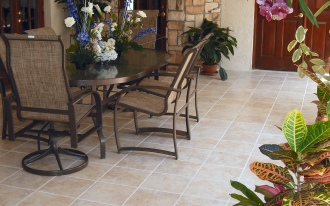 wrought iron framed table and chairs, tiled patio floor, pot plants and cut flowers